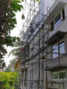 Plastering and structural work in progress on a multi-storey building in Kerala