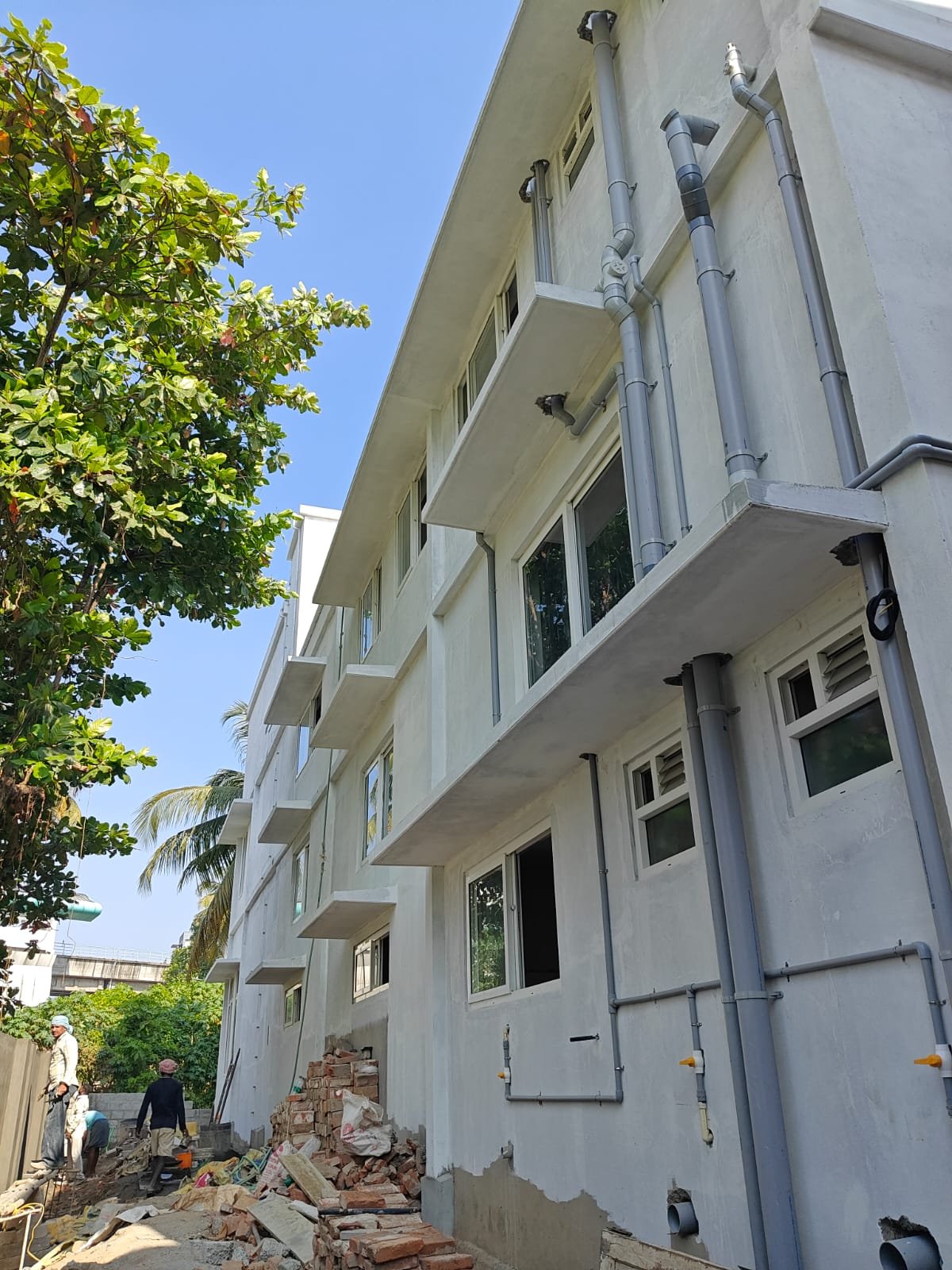Multi-storey building with completed plastering and finishing work by a building construction company in Kochi